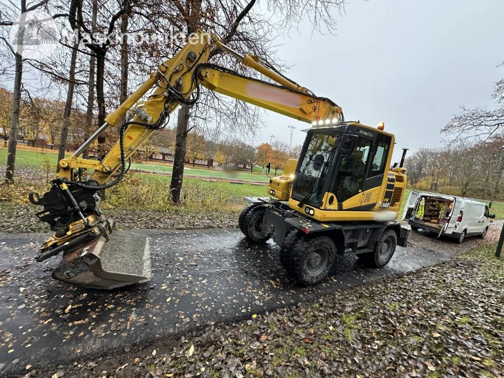Komatsu PW 148-11 med vagn och redskap - Mobiele graafmachine: afbeelding 1 Komatsu PW 148-11 med vagn och redskap - Mobiele graafmachine: afbeelding 1